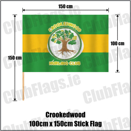 Crookedwood 100cm x 150cm Stick Flag in green and gold, featuring the club crest on realistic fabric with gentle vertical folds; County Westmeath GAA. ClubFlags.ie.