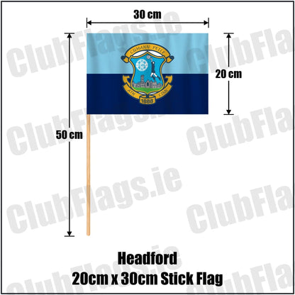 Headford 20cm x 30cm Stick Flag in sky-blue and navy, featuring the club crest on realistic fabric with gentle vertical folds; County Galway GAA. ClubFlags.ie.