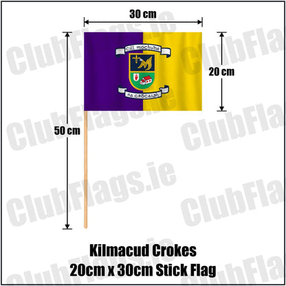 Kilmacud Crokes 20cm x 30cm Stick Flag in purple and gold, featuring the club crest on realistic fabric with gentle vertical folds; County Dublin GAA. ClubFlags.ie.