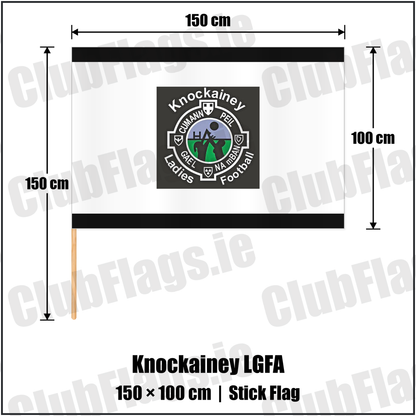 Knockainey LGFA 100cm x 150cm Stick Flag, featuring the Knockainey Ladies Football crest on black and solid white fabric with gentle vertical folds; County Limerick. ClubFlags.ie.
