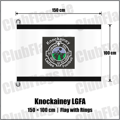 Knockainey LGFA 150cm x 100cm Flag Pole Flag with Rings, featuring the Knockainey Ladies Football crest on black and solid white fabric with gentle vertical folds; County Limerick. ClubFlags.ie.