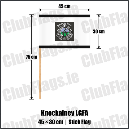 Knockainey LGFA 30cm x 45cm Stick Flag, featuring the Knockainey Ladies Football crest on black and solid white fabric with gentle vertical folds; County Limerick. ClubFlags.ie.