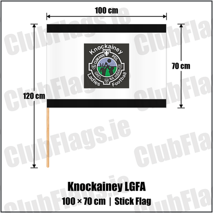 Knockainey LGFA 70cm x 100cm Stick Flag, featuring the Knockainey Ladies Football crest on black and solid white fabric with gentle vertical folds; County Limerick. ClubFlags.ie.