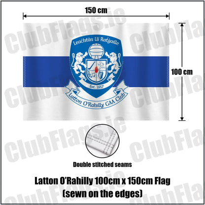 Latton O’Rahilly 100cm x 150cm Flag (sewn on the edges) in white and royal blue, featuring the club crest on realistic fabric with gentle vertical folds; County Monaghan GAA. ClubFlags.ie.