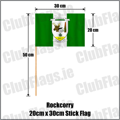 Rockcorry 20cm x 30cm Stick Flag in green and white, featuring the club crest on realistic fabric with gentle vertical folds; County Monaghan GAA. ClubFlags.ie.